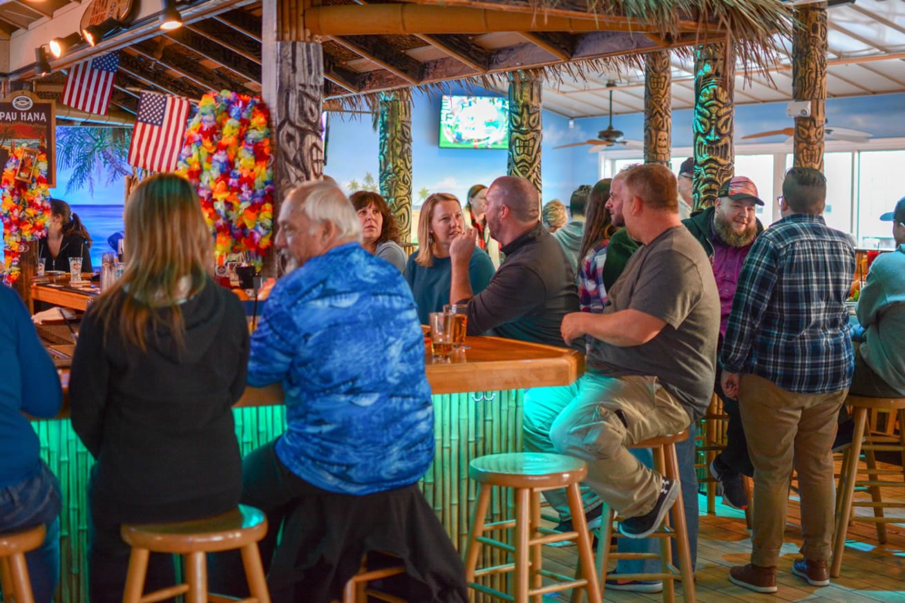 Friends gathered around the colorful Nalu bar